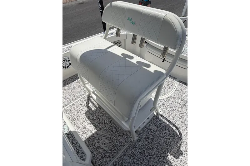 Slide: The Image of White cushioned seat on a 2019 Sea Vee 270Z boat, featuring rod holders. - 17
