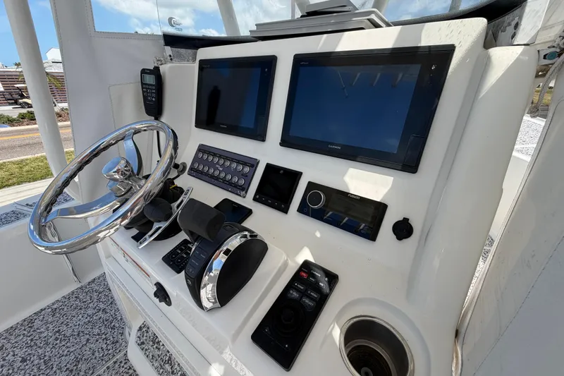 Slide: The Image of Control panel of a 2019 Sea Vee 270Z boat with steering wheel and electronic displays. - 19