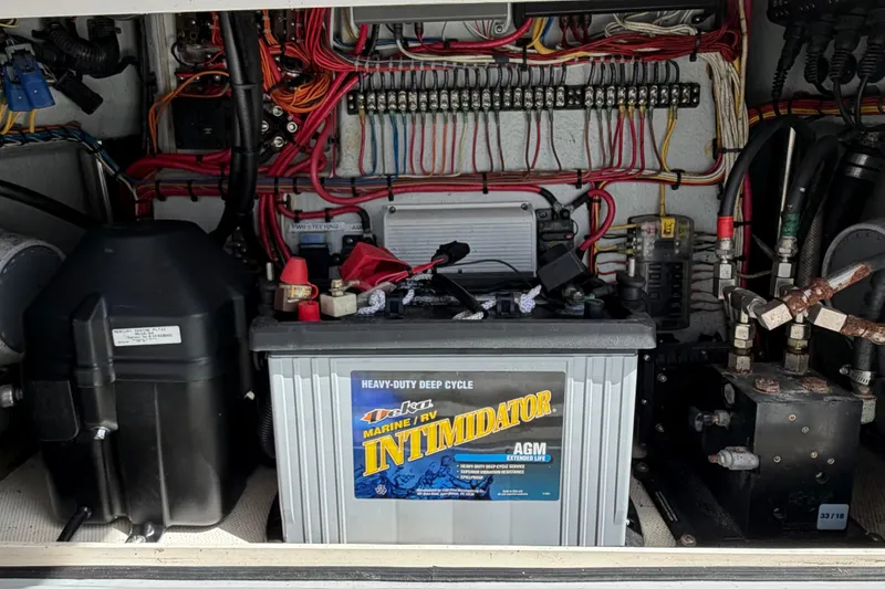Slide: The Image of 2019 Sea Vee 270Z boat battery compartment with wiring and marine equipment. - 21