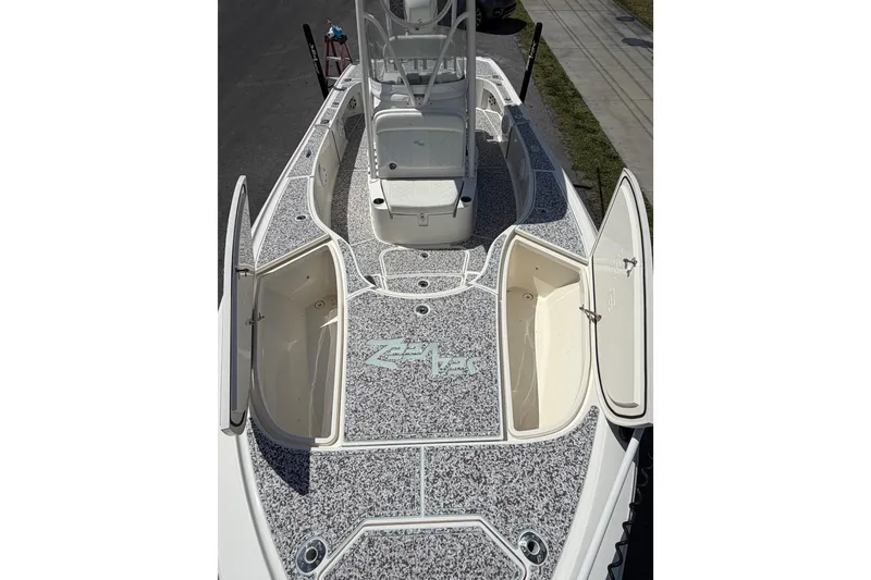 Slide: The Image of 2019 Sea Vee 270Z boat deck with open storage compartments and textured flooring. - 25