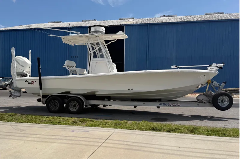 Slide: The Image of 2019 SeaVee 270Z boat on trailer in front of blue building. - 3