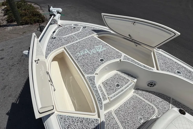 Slide: The Image of 2019 Sea Vee 270Z boat deck with open storage compartments and detailed flooring. - 34