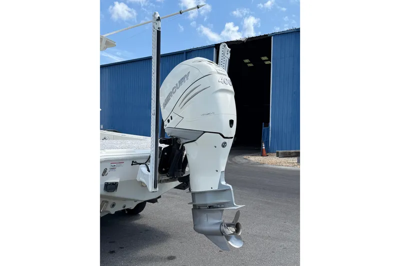 Slide: The Image of 2019 Sea Vee 270Z boat with Mercury 400 outboard engine near blue warehouse. - 4