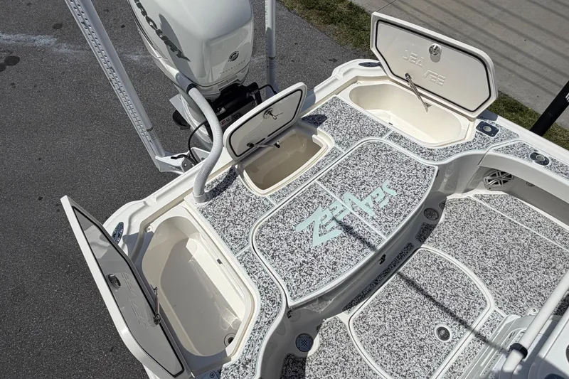 Slide: The Image of 2019 Sea Vee 270Z boat deck with open storage compartments and textured flooring. - 9