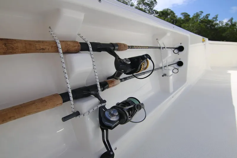 Slide: The Image of Manufacturer Provided Image: Fishing rods secured on a 2025 Sea Born FX21 Bay boat deck. - 13