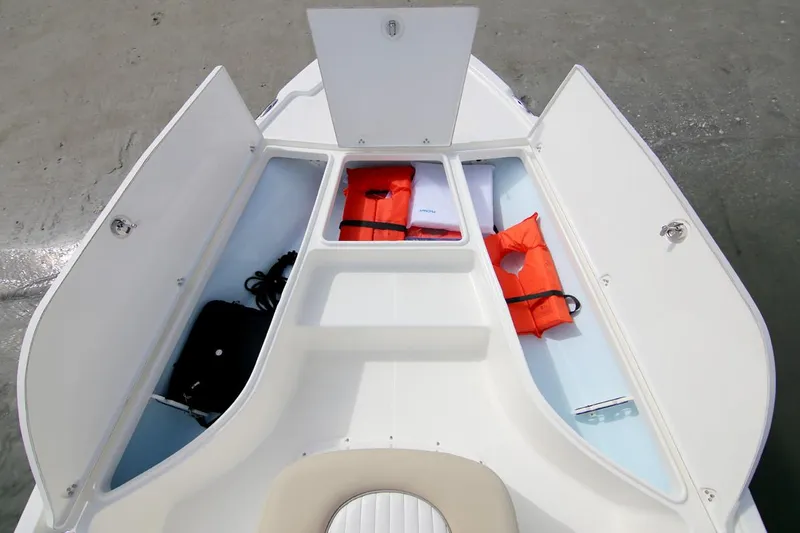 Slide: The Image of Manufacturer Provided Image: 2025 Sea Born FX21 Bay boat storage compartments with life jackets and gear. - 3