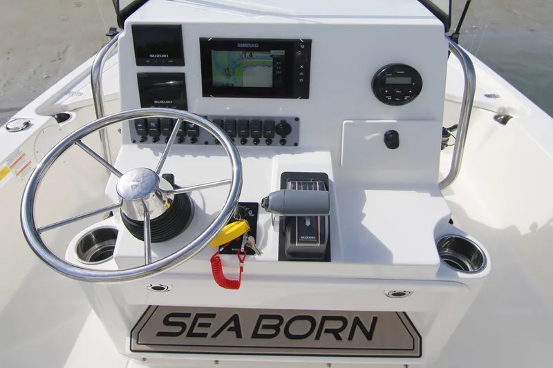 Slide: The Image of Manufacturer Provided Image: 2025 Sea Born FX21 Bay boat console with steering wheel and navigation controls. - 7