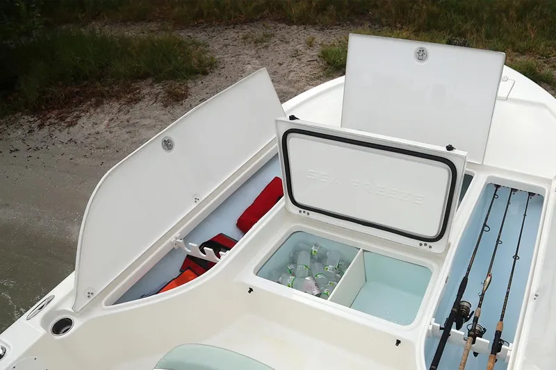 Slide: The Image of Manufacturer Provided Image: 2025 Sea Born FX22 Bay boat storage compartments with fishing rods and cooler. - 4