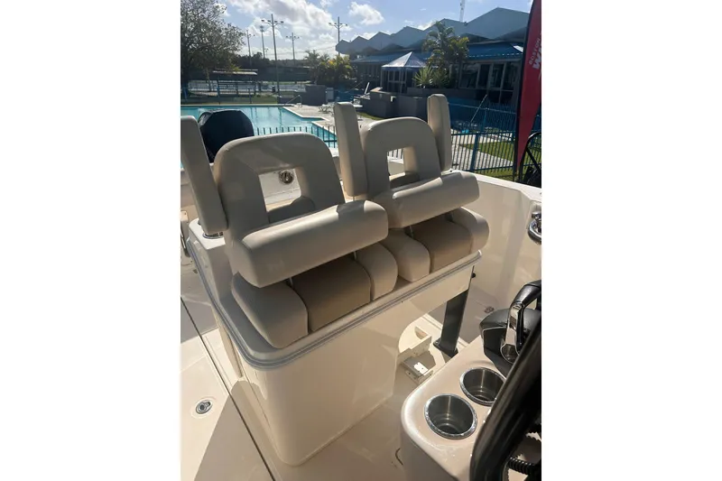 Slide: The Image of 2023 Boston Whaler 280 Outrage boat interior with dual cushioned seats and cup holders. - 10