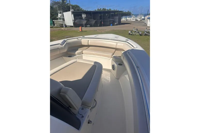 Slide: The Image of 2023 Boston Whaler 280 Outrage boat interior with beige seating and spacious deck. - 13