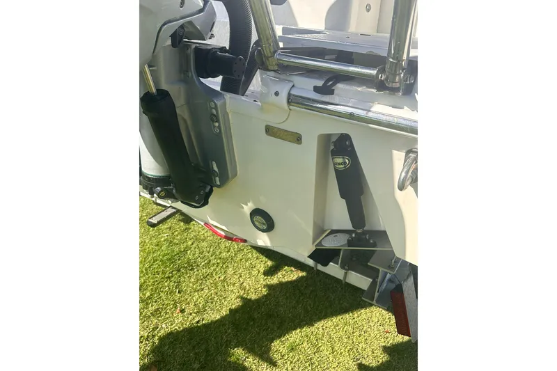 Slide: The Image of 2023 Boston Whaler 280 Outrage boat transom detail on grass. - 4