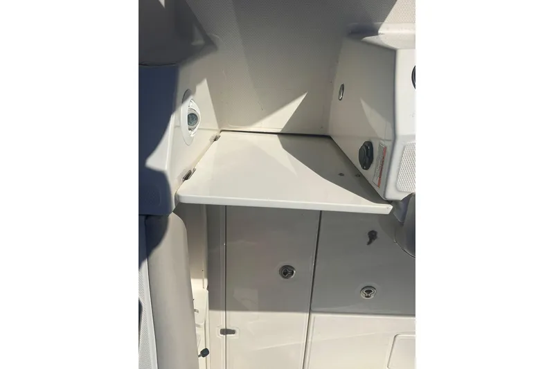 Slide: The Image of 2023 Boston Whaler 280 Outrage interior detail with storage compartment and utility features. - 5