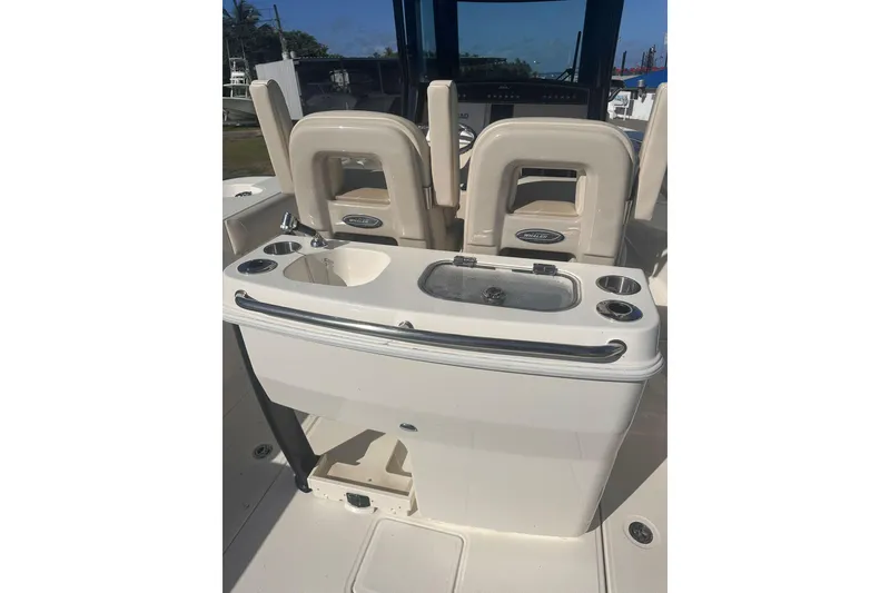 Slide: The Image of 2023 Boston Whaler 280 Outrage boat interior with sink and seating area. - 8