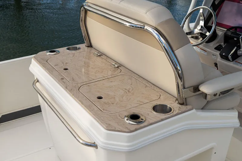 Slide: The Image of Manufacturer Provided Image: 2026 Boston Whaler 280 Dauntless boat interior with beige seating and cup holders. - 14