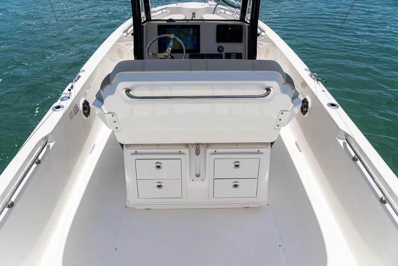 Slide: The Image of Manufacturer Provided Image: 2026 Boston Whaler 280 Dauntless boat interior with helm and storage drawers. - 16