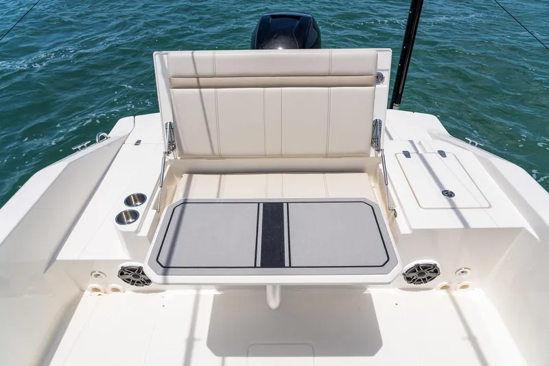 Slide: The Image of Manufacturer Provided Image: 2026 Boston Whaler 280 Dauntless boat interior with seating and cup holders on the water. - 17