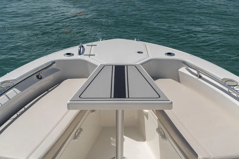 Slide: The Image of Manufacturer Provided Image: 2026 Boston Whaler 280 Dauntless boat interior with seating and table on water. - 9