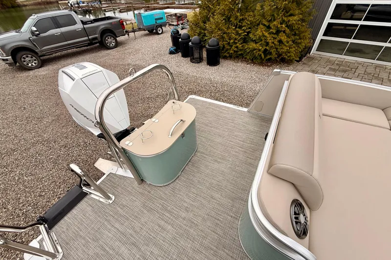 Slide: The Image of 2026 Tahoe Pontoon Cascade 25' VRL with Mercury outboard engine, docked near a truck. - 10