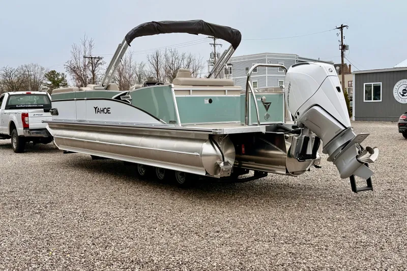 Slide: The Image of 2026 Tahoe Pontoon Cascade 25' VRL boat with outboard motor on gravel lot. - 4