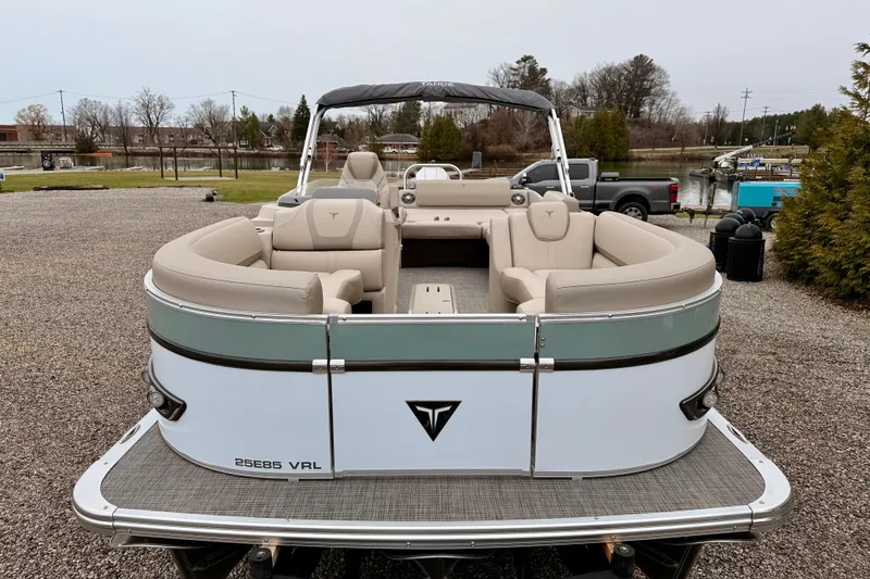 Slide: The Image of 2026 Tahoe Pontoon Cascade 25' VRL boat with beige seating, parked outdoors. - 7