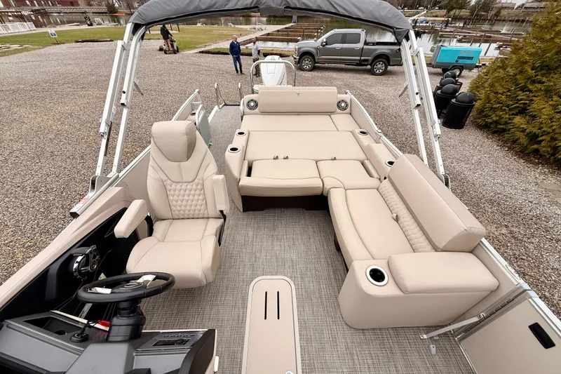 Slide: The Image of 2026 Tahoe Pontoon Cascade 25' VRL with luxurious beige seating and modern helm. - 9