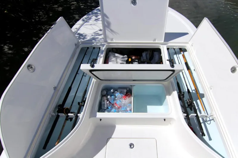 Slide: The Image of Manufacturer Provided Image: 2025 Sea Born FX24 Bay boat storage compartments with fishing rods and cooler. - 3