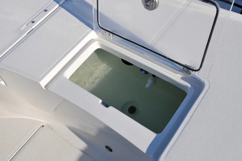 Slide: The Image of Manufacturer Provided Image: Livewell compartment on 2025 Sea Born FX24 Bay boat, open lid view. - 8