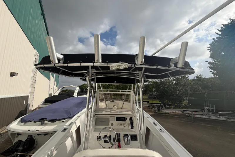 Slide: The Image of 1990 Mako 241 Center Console boat with T-top and fishing rod holders. - 10
