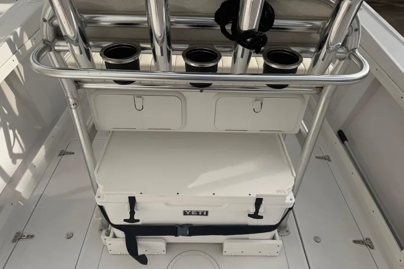 Slide: The Image of 1990 Mako 241 Center Console boat interior with rod holders and Yeti cooler. - 11