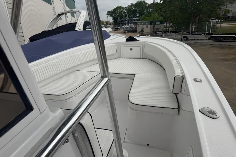 Slide: The Image of 1990 Mako 241 Center Console boat with white seating and sleek design. - 14