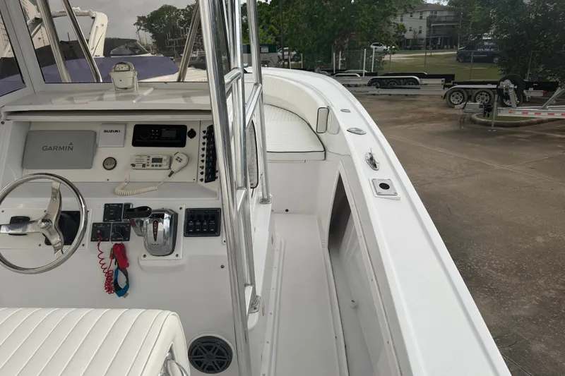 Slide: The Image of 1990 Mako 241 Center Console boat with Garmin navigation system and Suzuki controls. - 15