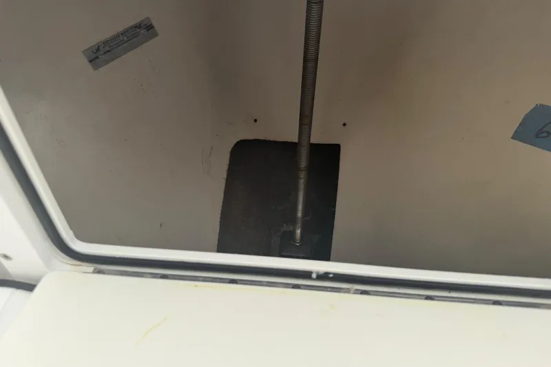 Slide: The Image of Interior view of a 1990 Mako 241 Center Console boat compartment. - 21