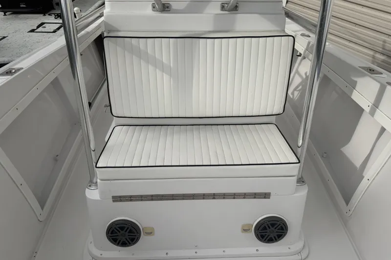 Slide: The Image of 1990 Mako 241 Center Console boat with white cushioned seating and stainless steel railings. - 22