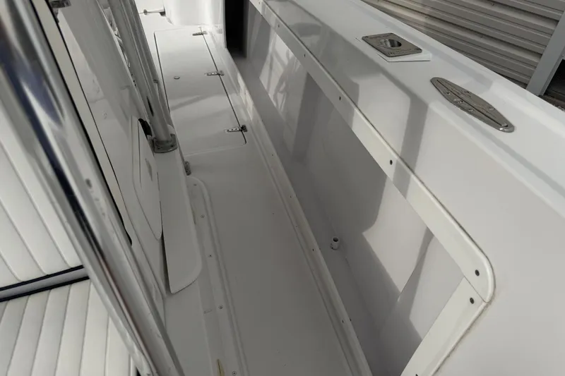 Slide: The Image of 1990 Mako 241 Center Console boat interior, showcasing clean white deck and seating. - 25