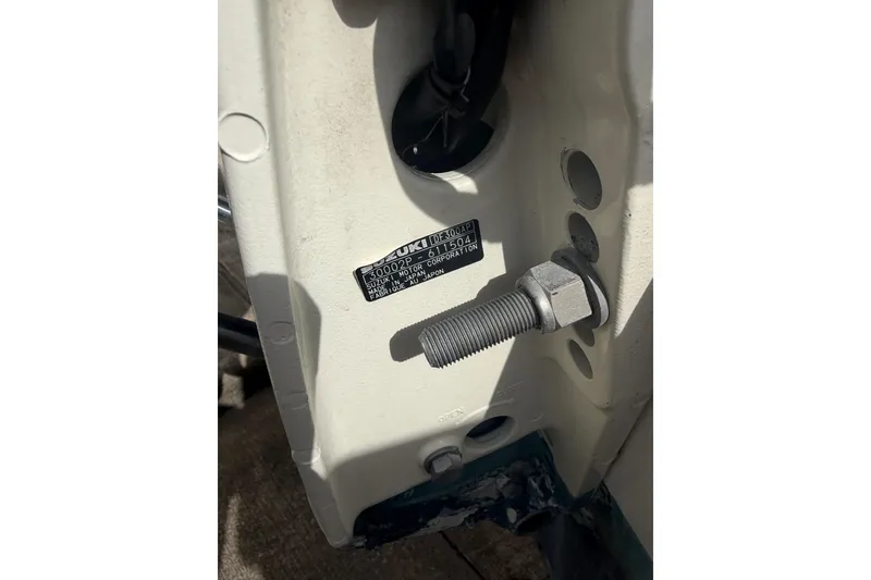 Slide: The Image of Close-up of a 1990 Mako 241 Center Console boat's engine mount with Suzuki label. - 34