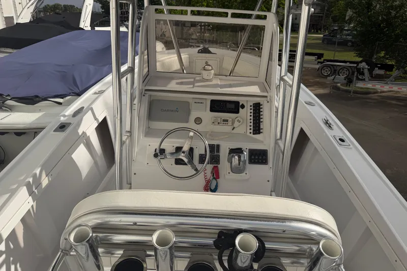 Slide: The Image of 1990 Mako 241 Center Console boat interior with steering wheel and navigation equipment. - 9