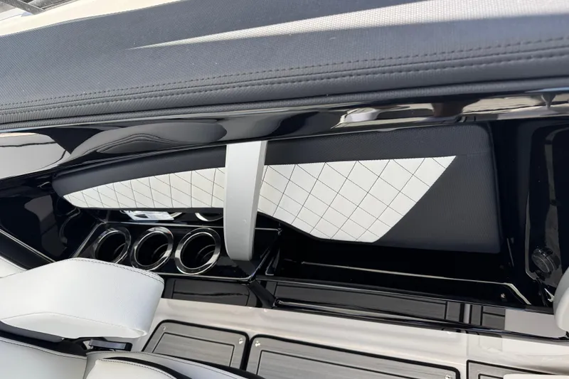 Slide: The Image of 2026 Yamaha Boats 275SD interior with sleek design and cup holders. - 16