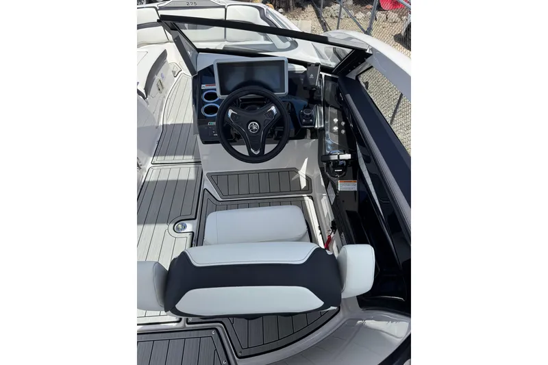 Slide: The Image of Interior view of 2026 Yamaha Boats 275SD helm with modern controls and seating. - 19