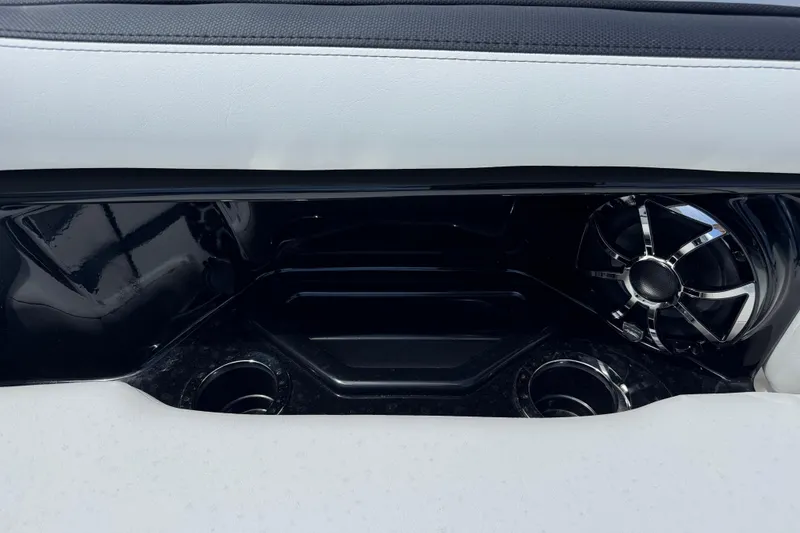 Slide: The Image of Interior detail of 2026 Yamaha Boats 275SD, featuring sleek speaker and cup holders. - 29