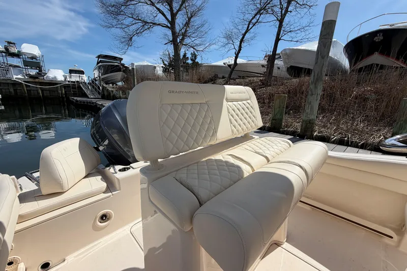 Slide: The Image of 2026 Grady-White Fisherman 216 boat interior with luxurious seating and waterfront view. - 10