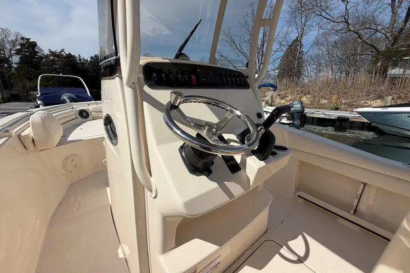 Slide: The Image of 2026 Grady-White Fisherman 216 boat interior with steering wheel and control panel. - 11