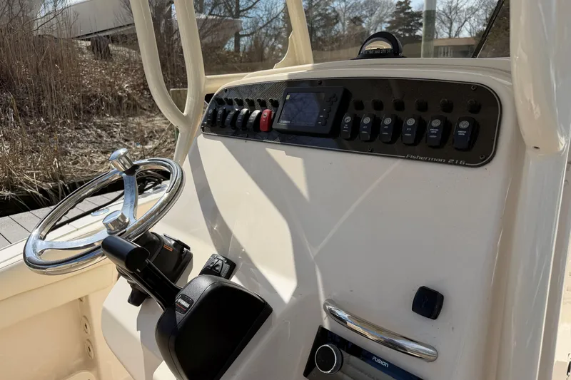 Slide: The Image of 2026 Grady-White Fisherman 216 boat console with steering wheel and control panel. - 12