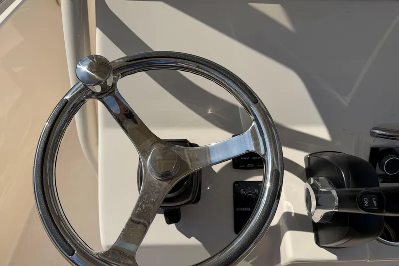 Slide: The Image of Steering wheel and controls of 2026 Grady-White Fisherman 216 boat. - 13