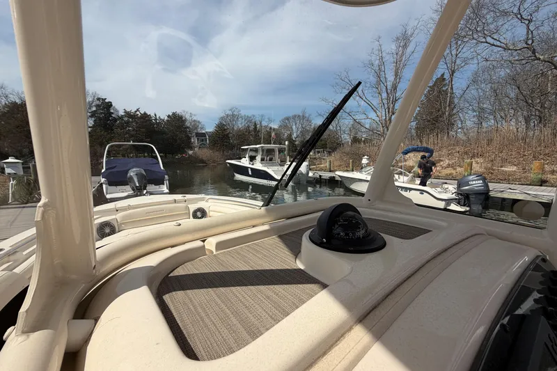 Slide: The Image of 2026 Grady-White Fisherman 216 boat docked, view from helm with compass. - 14