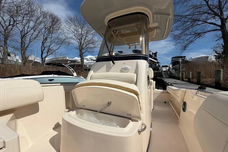 Slide: The Image of 2026 Grady-White Fisherman 216 boat interior with open storage, docked under clear sky. - 18