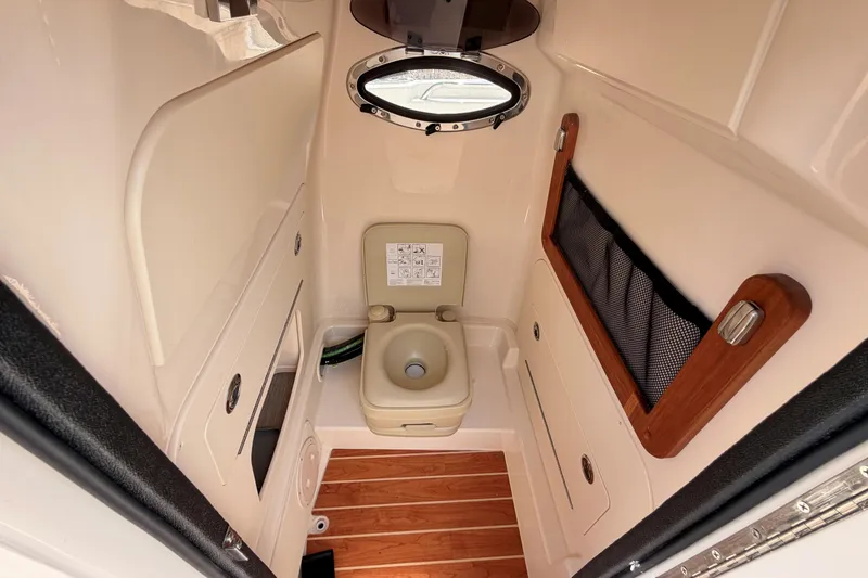 Slide: The Image of 2026 Grady-White Fisherman 216 boat interior with compact marine toilet and storage. - 21
