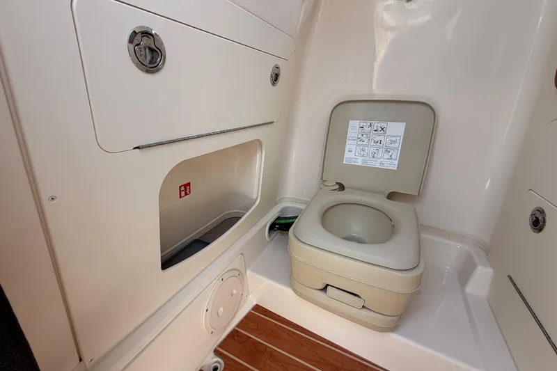 Slide: The Image of 2026 Grady-White Fisherman 216 boat interior with compact marine toilet. - 22