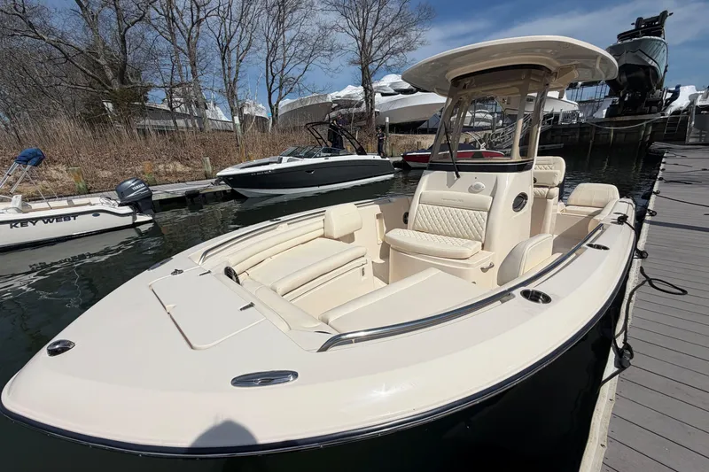 Slide: The Image of 2026 Grady-White Fisherman 216 boat docked, featuring sleek design and spacious seating. - 24