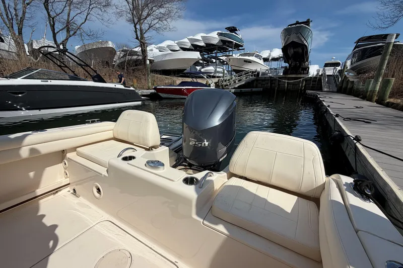 Slide: The Image of 2026 Grady-White Fisherman 216 boat docked, showcasing seating and powerful outboard motor. - 5