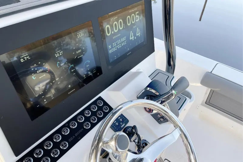 Slide: The Image of Manufacturer Provided Image: 2025 Sea Born FX25 Bay boat dashboard with digital displays and steering wheel. - 5